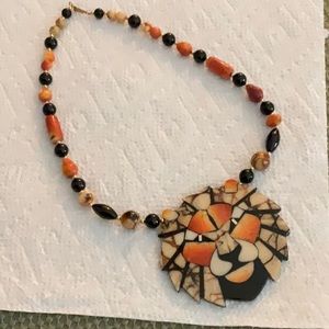 Unique lion necklace with inlaid stone and beaded necklace.